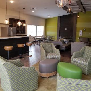 A modern lounge area with comfortable seating and bar stools.
