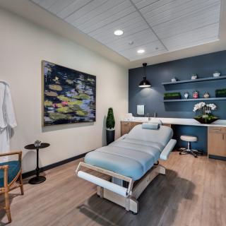 A serene and modern massage room with a treatment table, perfect for relaxation and wellness.