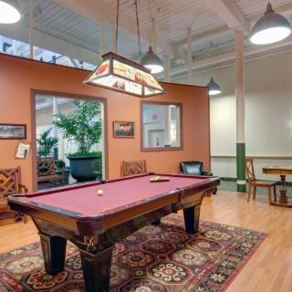 A cozy game room featuring a pool table and stylish decor.