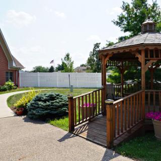A well-maintained backyard featuring a wooden gazebo with surrounding landscaping.
