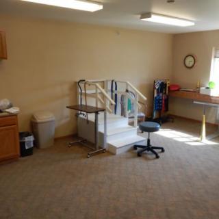 A physical therapy room equipped with rehabilitation stairs and various exercise tools.