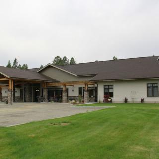 A modern residential building with a well-maintained lawn.