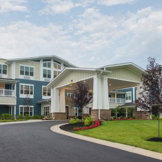 A modern residential building with an inviting entrance and well-maintained landscaping.