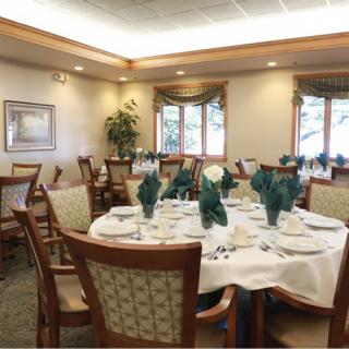 A beautifully set dining room with elegant decor and a formal table arrangement.