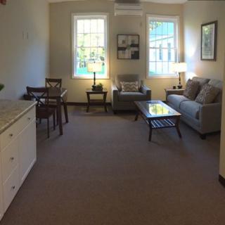 A cozy living room with seating area and dining space.
