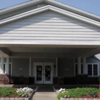 A suburban house entrance with a neatly maintained front yard.