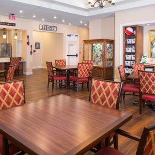 Comfortable dining area with wooden tables and patterned chairs.