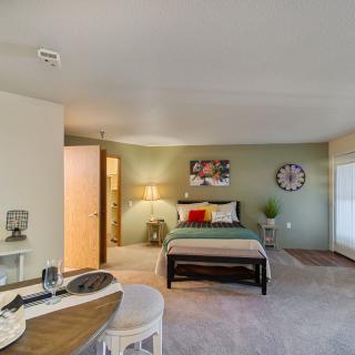 A modern, minimalist bedroom with cozy furnishings and a stylish interior design.