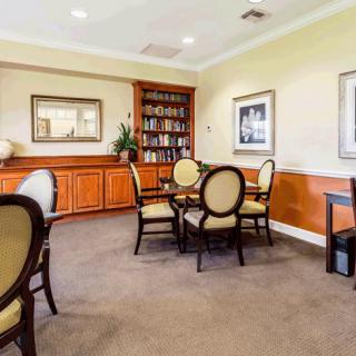 Cozy library seating area with bookshelves and elegant furniture.