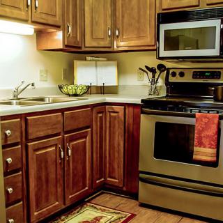 A cozy kitchen with wooden cabinets and stainless steel appliances.