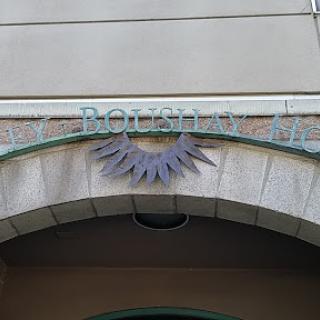 A decorative entrance with a sign above, showcasing architectural details.
