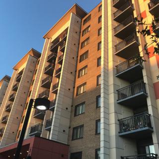 A residential apartment building illuminated by the warm glow of sunset.