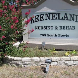Sign of Keeneland Nursing & Rehab surrounded by colorful landscaping.