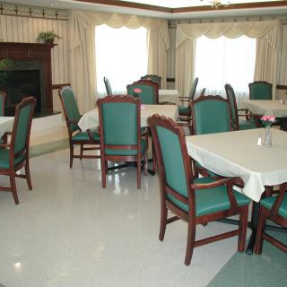 A bright dining room with tables and chairs arranged for seating.