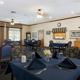 A cozy dining room with elegantly set tables and comfortable seating.