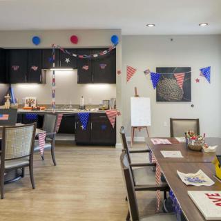 A festive kitchen and dining area decorated with colorful bunting and party elements.