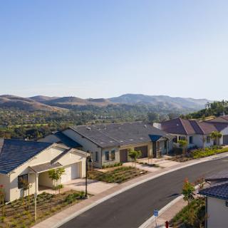A serene suburban neighborhood featuring modern homes with mountain views.