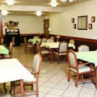 An empty restaurant dining area with tables and chairs.