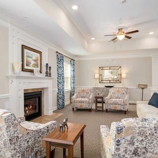 A cozy living room with elegant furniture and a warm fireplace.