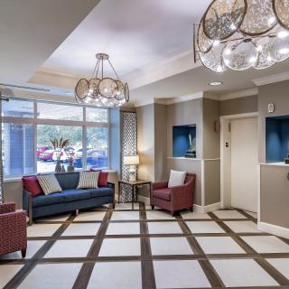 A stylish and modern lobby with elegant chandeliers and comfortable seating.