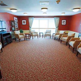 A spacious room with arranged seating and large windows.