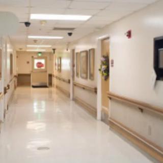 An empty hospital corridor with bright lighting and clean surroundings.