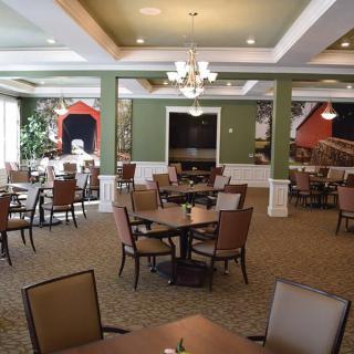 An elegantly decorated dining room with tables and chairs neatly arranged.