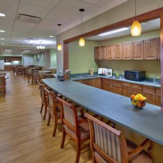 A spacious kitchen and dining area with wooden furniture and pendant lighting.