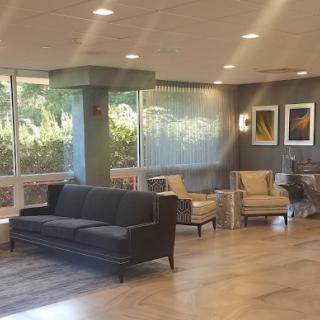 A modern lobby with comfortable seating and large windows.