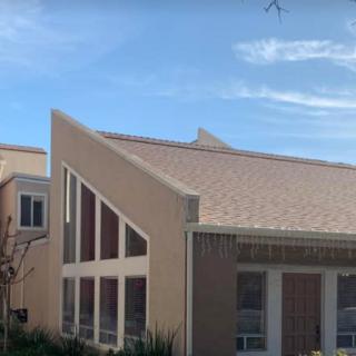A modern building with a unique roof design and large windows.