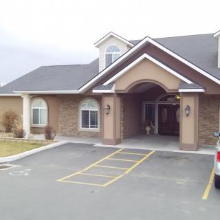 A view of a commercial building with brick architecture and a parking lot.