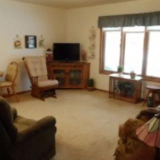A cozy living room with comfortable seating and a television.