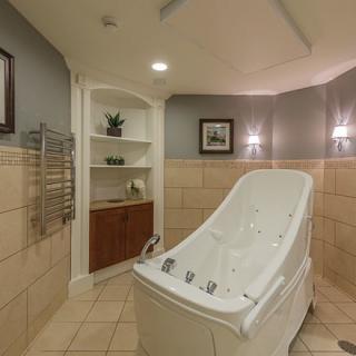 A luxurious spa bathroom featuring a sleek bathtub and elegant interior design.