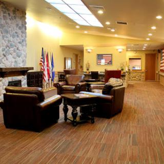 A welcoming lobby space featuring comfortable seating and decorative flags.