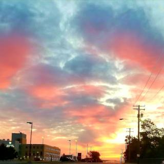 A breathtaking sunset paints the sky with vibrant hues over the city.
