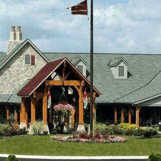 A picturesque building with a flagpole and well-maintained landscaping.
