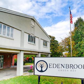 Edenbrook facility with an American flag in the background, showcasing a welcoming environment.