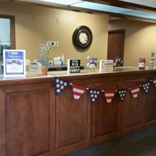 A reception area decorated with a patriotic flag banner and various informational displays on the counter.