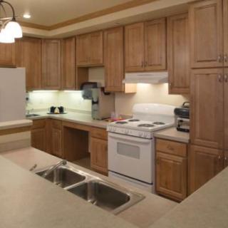 A cozy kitchen with wooden cabinets and modern appliances.