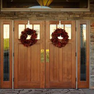 Double wooden doors adorned with festive wreaths.