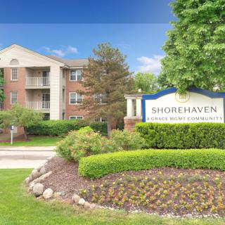 An apartment complex with well-maintained landscaping and a sign for Shorehaven.