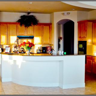 A cozy kitchen with wooden cabinets and a white countertop.