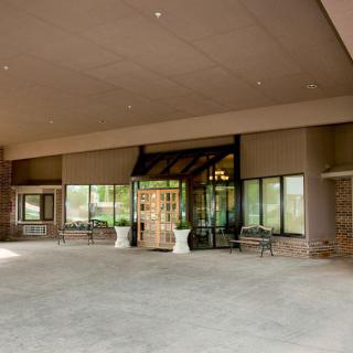 The main entrance of a building with glass doors and large windows.