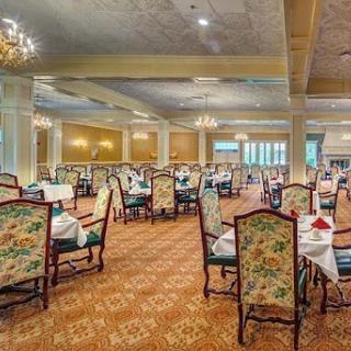 A beautifully designed dining area featuring elegant furniture and ample natural light.