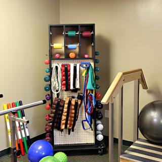 A well-organized setup of exercise and rehabilitation equipment in a therapy room.