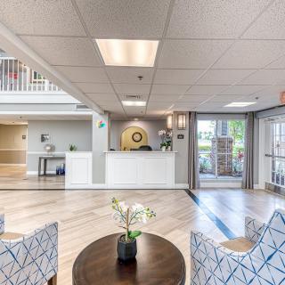 A modern and inviting lobby with a reception desk, comfortable seating, and stylish decor.
