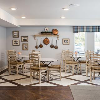 A cozy cafe interior with rustic decor and neatly arranged tables and chairs.