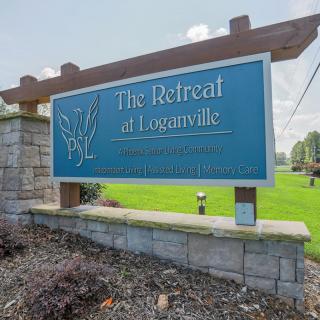 Entrance sign for The Retreat at Loganville residential area.