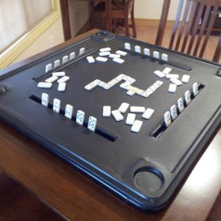 A game of dominoes set up on a table, ready for players to enjoy.