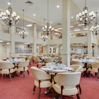 An elegant restaurant interior with chandeliers and well-arranged dining tables.